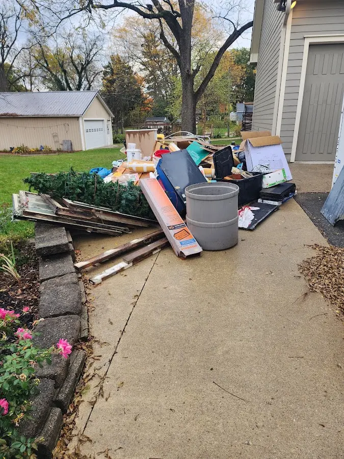 Dumpster being loaded with debris for Estate Cleanout Dumpster Rental in Hudson